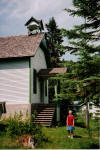 Edith Smith, former student, in front of school